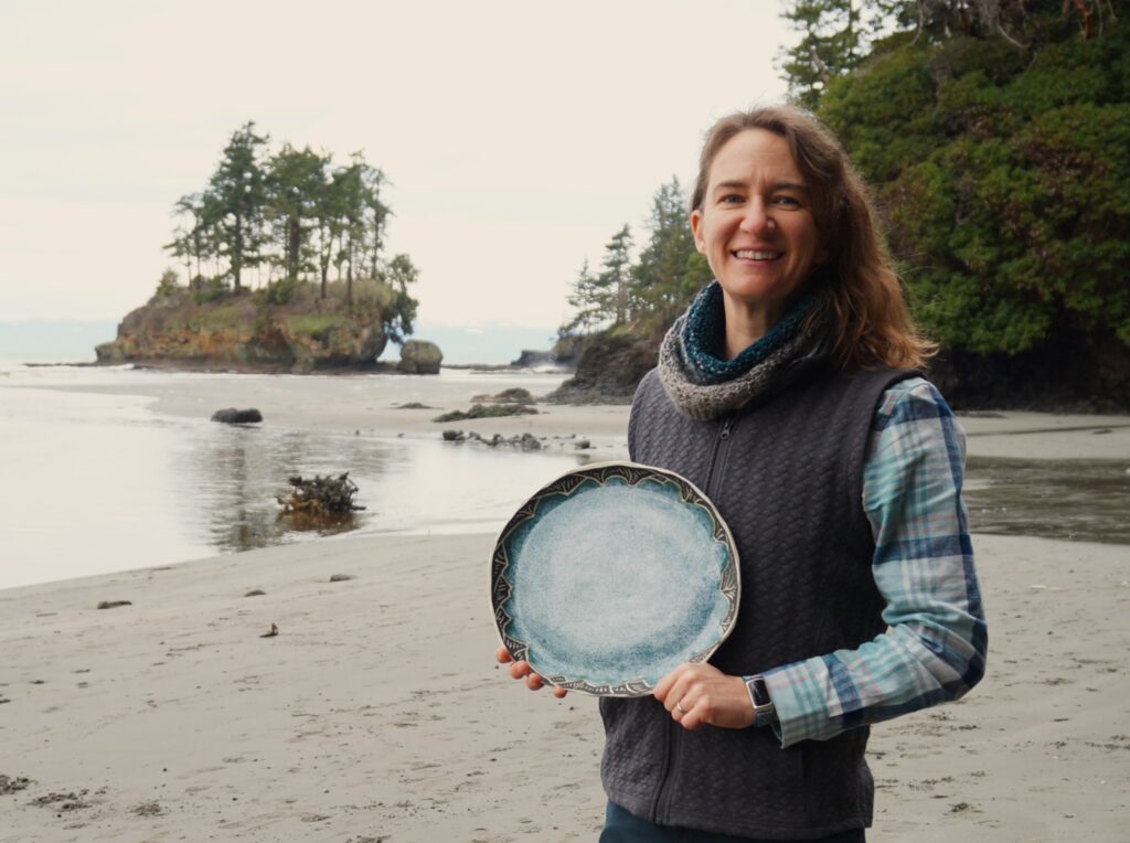 Woman holding a platter on a beach